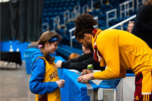 The Rogues players connect with young fans after each series. PHOTO CREDIT: Robert Greeley/Newfoundland Rogues