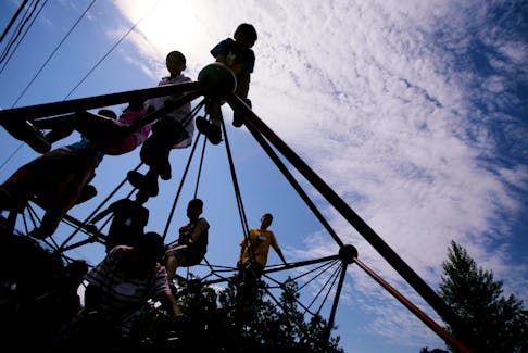 Grade three and four students climb a new addition to the school's playground facilities Tuesday, June 26, 2007 at John MacNeil School in Dartmouth.