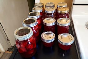 Rather than buying $4 jam from the store, Laura Graham will make a dozen jars of jam from a $4 bag of sugar, some wild-picked produce and her own two hands. Pictured is some of her preserved crab apples and crab apple jelly. Contributed