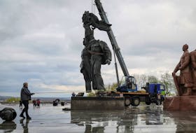 A Soviet monument to a friendship between Ukrainian and Russian nations is seen during its demolition, in central Kyiv, Ukraine, April 26, 2022. REUTERS/Gleb Garanich  A Soviet monument to a friendship between Ukrainian and Russian nations is seen during its demolition, in central Kyiv, Ukraine on Wednesday. REUTERS/Gleb Garanich