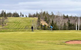 Golfers chipping onto the green at the Mountain Golf and Country Club April 20. Richard MacKenzie