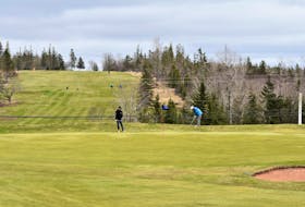 Golfers chipping onto the green at the Mountain Golf and Country Club April 20. Richard MacKenzie