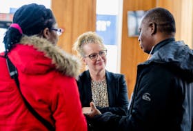 Arlene Dunn, the minister responsible for Immigration and for Opportunities New Brunswick, chats with newcomers at an event in Saint John, N.B. on May 2. Contributed