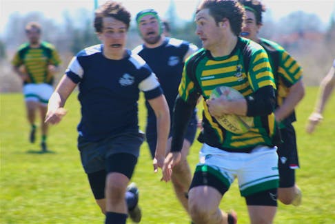 Three Oaks Senior High boy's rugby player Kale Wood, right, runs the ball down the field before scoring the final try of the match in the championship game of the David Voye Memorial rugby tournament on May 6. Wood's try put the game out of reach as TOSH took a 20-12 win over the Bluefield Bobcats in the final.