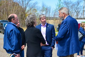 Representatives of the Valley Roots Housing Association speak with Premier Tim Houston and Kings North MLAJohn Lohr prior to a May 10 affordable housing announcement in New Minas. KIRK STARRATT