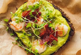 Transform the standard avocado toast brunch item to a Mother's Day worthy dish with the addition of roast peppers and shrimp.