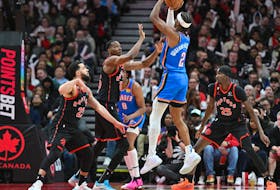 Oklahoma City Thunder's Shai Gilgeous-Alexander shoots the ball over Raptors' Christian Koloko and Fred VanVleet in the second half at Scotiabank Arena on March 16, 2023. 