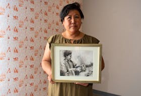 Artist JJ Lee poses for a photo with a drawing of her mother preparing dinner on Tuesday, May 9, 2023. Lee's exhibition, In My Yesterday, features artwork, photographs and historical documents which help tell the story of Lee's family and their immigration experience.
Ryan Taplin - The Chronicle Herald