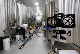 An employee does maintenance at the Good Robot Brewing Company facility in Elmsdale on Wednesday, May 10, 2023. - Tim Krochak