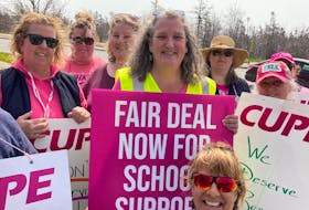 Tracey Sullivan, a longtime educational program assistance, middle, is among more than a dozen striking CUPE school support workers who walked the picket line near the Halifax Regional Centre for Education office in Dartmouth on Thursday, May 11, 2023. - Francis Campbell