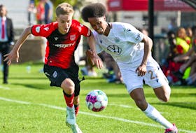 HFX Wanderers midfielder Mohamed Omar fights for the ball with Jesse Daley of Cavalry FC during Canadian Premier League play Saturday in Calgary. The teams played to a 2-2 draw. - MIKE STURK / CFC MEDIA