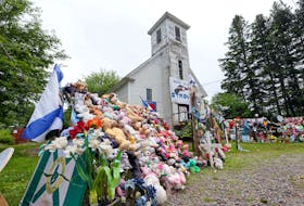 Items of condolence overflow on the steps and yard in front of the old Portapique Church on July 23, 2020. - Eric Wynne
