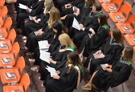 Students in the veterinary medicine and nursing faculties listen in on the UPEI convocation ceremony on May 16 at the UPEI Chi-Wan Young Sports Centre. Dave Stewart • The Guardian