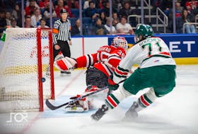 Halifax Mooseheads winger Evan Boucher tries to score on Quebec Remparts goalie William Rousseau during a QMJHL playoff game in Quebec City on Friday. - Jonthan Roy/QMJHL