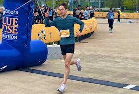 Brent Scheibelhut of Toronto crosses the finish line in 2:47:51 on the Emera Oval to win the men's full marathon at the Blue Nose Marathon in Halifax on Sunday morning. - GLENN MacDONALD / THE CHRONICLE HERALD