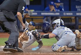 Home plate umpire Jordan Baker watches as Blue Jays catcher Alejandro Kirk, right, tags out Rays' Wander Franco, who was trying to score from third base on a throw from Toronto center fielder Kevin Kiermaier during the fifth inning on Monday, May 22, 2023, in St. Petersburg, Fla. 