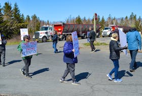 Members of the Cow Bay Environmental Coalition group and area residents stage a protest at the corner of the Morien Highway and Long Beach Road in Port Morien Tuesday morning. IAN NATHANSON/CAPE BRETON POST