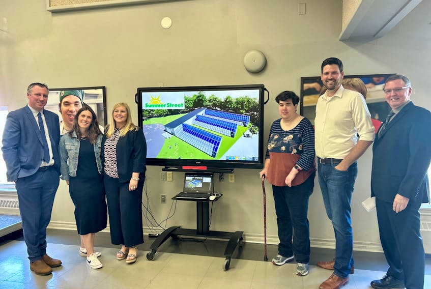From left to right: Greg Morrow, Rae Dunn, Karla MacFarlane, Tracy Hamilton, Sean Fraser and Bob Bennett next to a rendering of what the new greenhouse facility will look like.