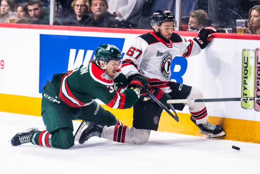 Halifax Mooseheads defenceman Dylan MacKinnon, left, and Quebec Remparts forward Daniel Agostino battle for the puck during Sunday's QMJHL playoff game at the Scotiabank Centre. - Vincent Ethier/QMJHL