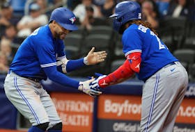 Toronto Blue Jays right fielder George Springer, left, celebrates with first baseman Vladimir Guerrero Jr. after he hits a home run during the third inning against the Tampa Bay Rays at Tropicana Field in St. Petersburg, Fla., May 23, 2023.