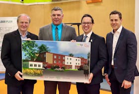 Egmont MP Bobby Morrissey, Boys and Girls Club executive director Adam Binkley, City of Summerside Mayor Dan Kutcher and  Housing, Land and Communities Minister Rob Lantz holding the plan for 24 new affordable housing units through the Boys & Girls Club Prince County’s Affordable Housing Initiative. Handout