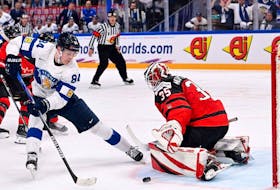 Canadian goalie Sam Montembeault stymies Finnish forward Kaapo Kakko during the world championship quarterfinals yesterday in Tampere, Finland.