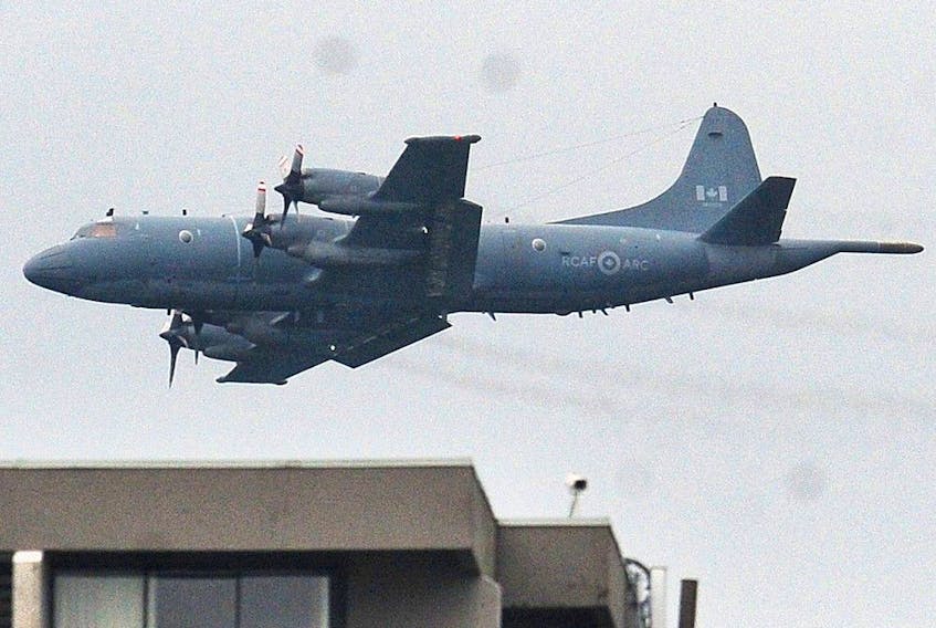 A 2019 file photo of a CP-140 Aurora airplane doing a flyby over Stanley Park in Vancouver.