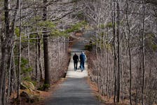A couple walk on a bridge near Frog Pond at Sir Sandford Fleming Park in Halifax, Monday, April 9, 2012. (ADRIEN VECZAN/Staff)