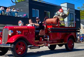 Sparky the Fire Dog waves from the back of an antique fire truck during the Annapolis Valley Apple Blossom Festival children's parade Saturday morning in Kentville.