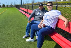 Craig Christmas, left, and his son Chaz talk football at Open Hearth Park Sports Field, the home field for Sydney Academy. BARB SWEET/CAPE BRETON POST