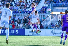 HFX Wanderers defender Riley Ferrazzo wins an airborne battle against Pacific FC's Thomas Meilleur and heads the ball away during Canadian Premier League play Saturday night in Langford, B.C. The teams finished in a 1-1 draw. - CANADIAN PREMIER LEAGUE 