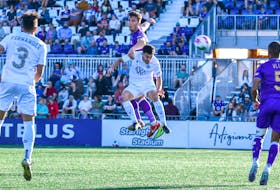 HFX Wanderers defender Riley Ferrazzo wins an airborne battle against Pacific FC's Thomas Meilleur and heads the ball away during Canadian Premier League play Saturday night in Langford, B.C. The teams finished in a 1-1 draw. - CANADIAN PREMIER LEAGUE 