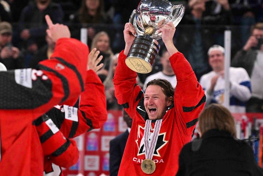 Canada's forward Tyler Toffoli (R) holds up the trophy as they celebrate winning the IIHF Ice Hockey Men's World Championships final match betweeen Canada and Germany in Tampere, Finland, on May 28, 2023.