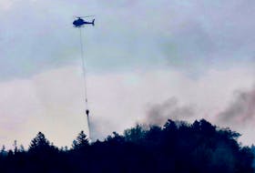 FOR NEWS STORY:
A Department of Natural Resources helicopter drops water over a fire near Hammonds Plains Road near Yankeetown, May 29, 2023.

TIM KROCHAK PHOTO