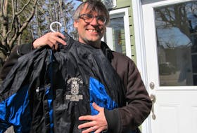 Rev. Joseph Mitchell, holding a championship soccer jacket from 1997; has had quite a sports background. Contributed