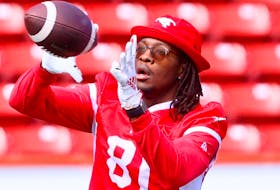 Calgary Stampeders' Luther Hakunavanhu catches a ball during their walkthrough.