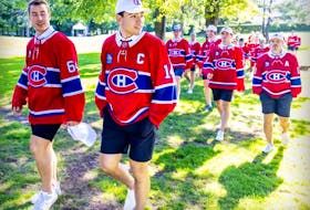 Canadiens' Nick Suzuki leads his teammates at their annual golf tournament in Laval last September. Suzuki spent last summer in the city, and is doing so again this summer.
