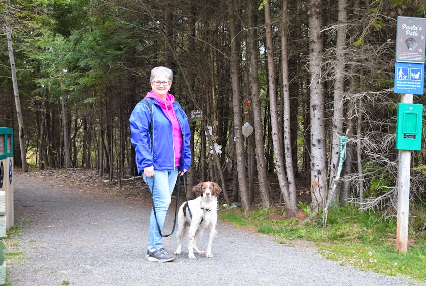 Nancy Brightman-Crosby and her dog Rhys will be participating in the 50 km Dog Walk Challenge for the Canadian Cancer Society for the month of June. They’re pictured at the start of Paula’s Path, named in memory of a former softball teammate and friend of Brightman-Crosby – Paula MacDonald - one of the too many people she knows who have lost their lives to the disease or it has impacted, which is motivating her participation. Richard MacKenzie