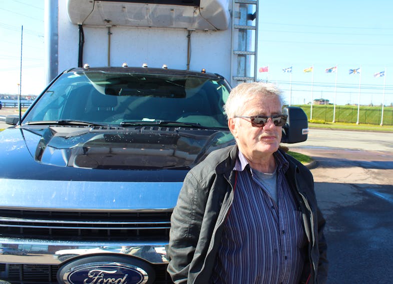 Ernie Maddix, owner of Maddix Seafoods, stands in front of his 2022 Ford F-550 in Charlottetown on May 27. His windshield was recently cracked by two separate drivers after gravel flew off the tops of their trucks and hit his car. Rafe Wright • The Guardian