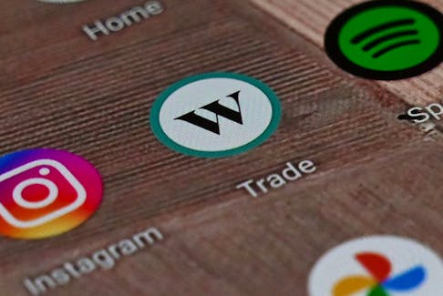 A Wealthsimple Trade app on a smartphone. Canadian fintechs have not been hit as hard as regional banks in the United States. 