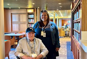 Leonard Wood and his daughter, Robin John, check out the library onboard Zaandam as part of their tour on May 31 in Charlottetown. Thinh Nguyen • The Guardian