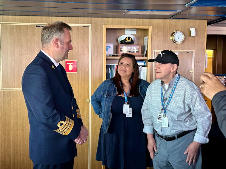 The ship's captain, Ane Smit, left, chats with Leonard Wood and his daughter, Robin John, as they tour the bridge on Zaandam May 31. Thinh Nguyen • The Guardian