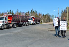 Two transport trucks sit idling as protesters stage a rally blocking the entrance of Long Beach Road in Port Morien on Tuesday morning. IAN NATHANSON/CAPE BRETON POST
