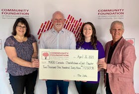 Brenda Simmons, left, mother of Jacob Simmons, Norman Beck, chairperson of The Jake, and Kent Hudson, right, CFPEI executive director, present Karen Clinton, MADD Charlottetown volunteer, with a donation. Contributed