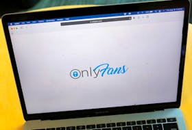 The OnlyFans logo displayed on a laptop.
