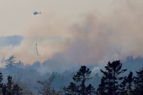 A natural resources helicopter drops water on a blaze behind Farmers Dairy on Hammonds Plains Road….they were assisting Halifax fire near Bedford, May 30, 2023.

TIM KROCHAK PHOTO