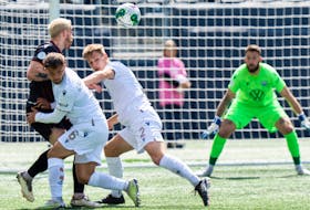 HFX Wanderers keeper Yann Fillion keeps his eyes on the ball as his teammates Daniel Nimick and Lorenzo Callegari battle for possession during Canadian Premier League action Saturday afternoon in Winnipeg. The Wanderers and Valour played to a 0-0 draw. - CANADIAN PREMIER LEAGUE