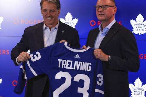 Toronto Maple Leafs president Brendan Shanahan (left) and Brad Treliving hold up a team jersey.