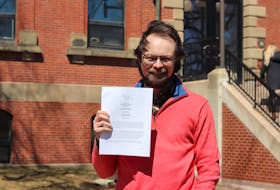 Nate Hood, Green party staffer, holds an order from the privacy commissioner, which orders Charlottetown to release several documents related to short term rental regulations. Logan MacLean • The Guardian