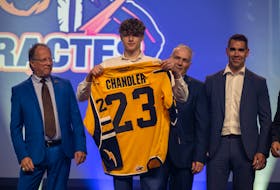 Members of the Shawinigan Cataractes staff pose with first-round pick Cole Chandler of Bedford at the QMJHL draft in Sherbrooke, Que., on Saturday. - QMJHL